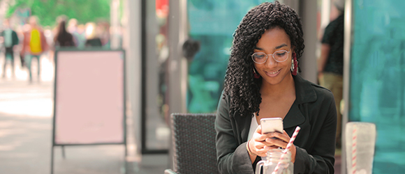 Woman at cafe on cell phone.